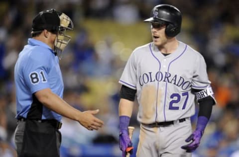 April 19, 2017; Los Angeles, CA, USA; Colorado Rockies shortstop Trevor Story (27) argues a strike out call to home plate umpire Quinn Wolcott (81) in the ninth inning against the Los Angeles Dodgers at Dodger Stadium. Mandatory Credit: Gary A. Vasquez-USA TODAY Sports