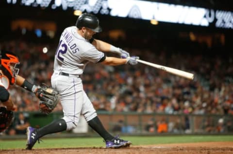 Jun 27, 2017; San Francisco, CA, USA; Colorado Rockies first baseman Mark Reynolds (12) hits a double against the San Francisco Giants during the eighth inning of the game at AT&T Park. Mandatory Credit: Stan Szeto-USA TODAY Sports