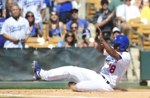 Chone Figgins slide into third base during spring training