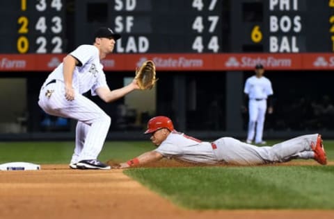 Sep 20, 2016; Denver, CO, USA; St. Louis Cardinals second baseman Kolten Wong (16) dives into the second base against Colorado Rockies second baseman DJ LeMahieu (9) after a wild pitch in the first inning at Coors Field. Mandatory Credit: Ron Chenoy-USA TODAY Sports