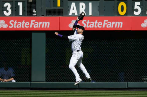 Oct 2, 2016; Denver, CO, USA; Colorado Rockies right fielder Carlos Gonzalez (5) makes a catch in the first inning against the Milwaukee Brewers at Coors Field. Mandatory Credit: Isaiah J. Downing-USA TODAY Sports