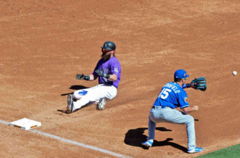 Mar 13, 2017; Salt River Pima-Maricopa, AZ, USA; Colorado Rockies center fielder Charlie Blackmon (19) slides as Kansas City Royals second baseman Whit Merrifield (15) waits for the ball during the third inning during a spring training game at Salt River Fields at Talking Stick. Mandatory Credit: Matt Kartozian-USA TODAY Sports