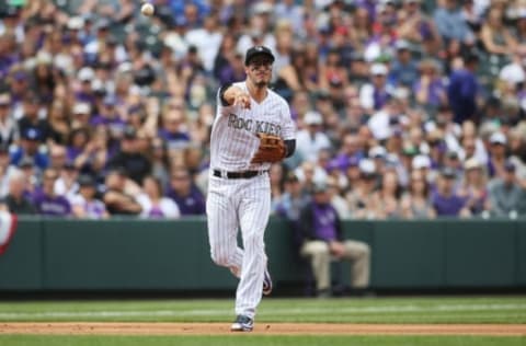 Apr 7, 2017; Denver, CO, USA; Colorado Rockies third baseman Nolan Arenado (28) fields a ground ball during the first inning against the Los Angeles Dodgers at Coors Field. Mandatory Credit: Chris Humphreys-USA TODAY Sports