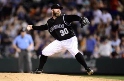 Jul 21, 2016; Denver, CO, USA; Colorado Rockies relief pitcher Jason Motte (30) delivers a pitch in the ninth inning against the Atlanta Braves at Coors Field. The Rockies defeated the Braves 7-3. Mandatory Credit: Ron Chenoy-USA TODAY Sports