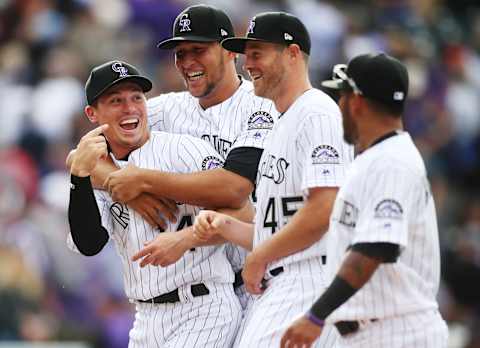 Apr 7, 2017; Denver, CO, USA; Colorado Rockies catcher Tony Wolters (left), relief pitchers Carlos Estevez (middle back), and Scott Oberg (45) celebrate after the game against the Los Angeles Dodgers at Coors Field. Mandatory Credit: Chris Humphreys-USA TODAY Sports