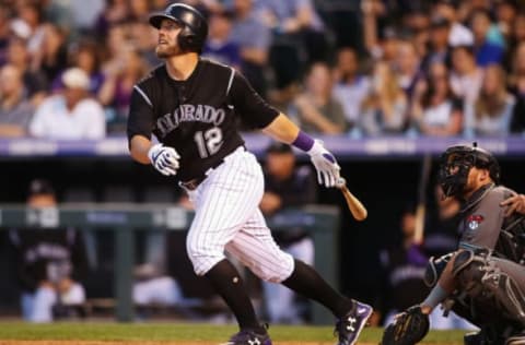 May 5, 2017; Denver, CO, USA; Colorado Rockies first baseman Mark Reynolds (12) hits a solo home run during the fourth inning against the Arizona Diamondbacks at Coors Field. Mandatory Credit: Chris Humphreys-USA TODAY Sports