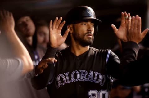 May 11, 2017; Denver, CO, USA; Colorado Rockies left fielder Ian Desmond (20) is greeted in the dugout by teammates after scoring during the fourth inning against the Los Angeles Dodgers at Coors Field. Mandatory Credit: Chris Humphreys-USA TODAY Sports