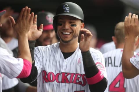 May 14, 2017; Denver, CO, USA; Colorado Rockies right fielder Carlos Gonzalez (5) celebrates with teammates in the dugout after scoring during the eighth inning against the Los Angeles Dodgers at Coors Field. Mandatory Credit: Chris Humphreys-USA TODAY Sports