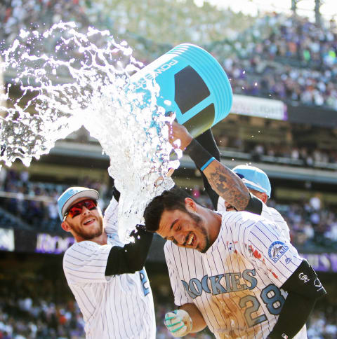 Jun 18, 2017; Denver, CO, USA; Colorado Rockies third baseman Nolan Arenado (28) is dunked with water after hitting a walk off three run home run to complete the cycle during the ninth inning against the San Francisco Giants at Coors Field. Mandatory Credit: Chris Humphreys-USA TODAY Sports