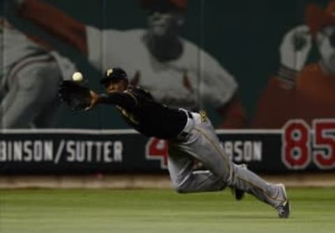 Oct 9, 2013; St. Louis, MO, USA; Pittsburgh Pirates left fielder Starling Marte (6) makes a diving catch against the St. Louis Cardinals in the third inning in game five of the National League divisional series playoff baseball game at Busch Stadium. Mandatory Credit: Jeff Curry-USA TODAY Sports