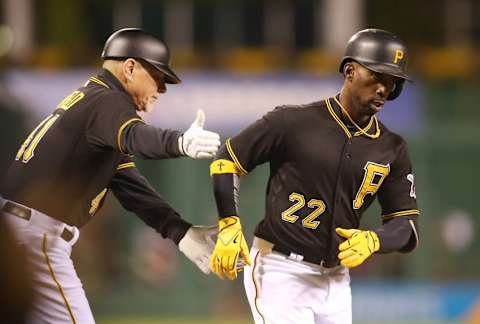 Oct 2, 2015; Pittsburgh, PA, USA; Pittsburgh Pirates third base coach Rick Sofield (41) greets center fielder Andrew McCutchen (22) after McCutchen hit a solo home run against the Cincinnati Reds during the fourth inning at PNC Park. Mandatory Credit: Charles LeClaire-USA TODAY Sports