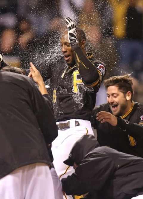 Oct 2, 2015; Pittsburgh, PA, USA; Pittsburgh Pirates left fielder Starling Marte (center) celebrates with teammates after hitting a two run game winning walk-off home run against the Cincinnati Reds during the twelfth inning at PNC Park. The Pirates won 6-4 in twelve innings. Mandatory Credit: Charles LeClaire-USA TODAY Sports