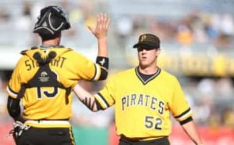 Apr 17, 2016; Pittsburgh, PA, USA; Pittsburgh Pirates catcher Chris Stewart (19) and relief pitcher Rob Scahill (52) celebrate after defeating the Milwaukee Brewers at PNC Park. The Pirates won 9-3. Mandatory Credit: Charles LeClaire-USA TODAY Sports