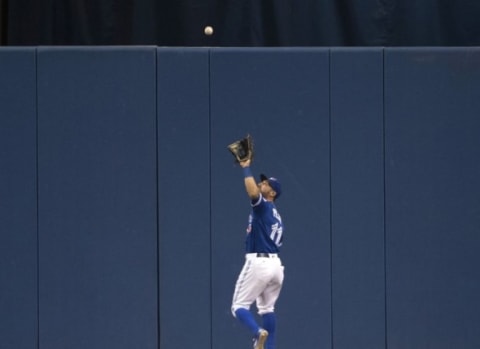 Apr 23, 2016; Toronto, Ontario, CAN; Toronto Blue Jays center fielder Kevin Pillar (11) catches a fly ball during the sixth inning in a game against the Oakland Athletics at Rogers Centre. Mandatory Credit: Nick Turchiaro-USA TODAY Sports