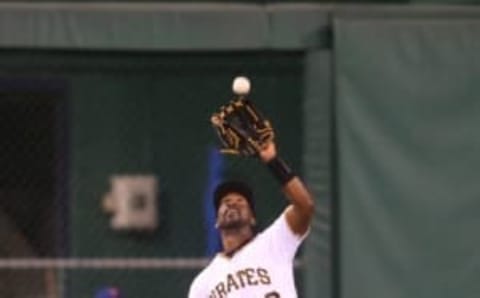 Jun 7, 2016; Pittsburgh, PA, USA; Pittsburgh Pirates center fielder Andrew McCutchen (22) makes a catch in the outfield against the New York Mets during the seventh inning in game two of a double header at PNC Park. Mandatory Credit: Charles LeClaire-USA TODAY Sports