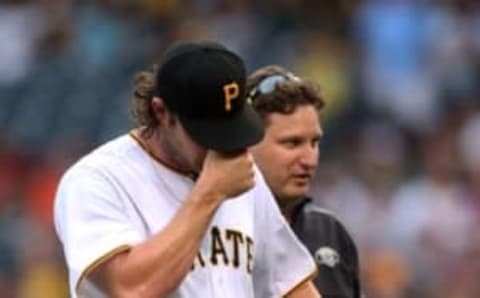 Jun 10, 2016; Pittsburgh, PA, USA; Pittsburgh Pirates starting pitcher Gerrit Cole (45) leaves the game accompanied by trainer Todd Tomczyk (right) during the third inning against the St. Louis Cardinals at PNC Park. Mandatory Credit: Charles LeClaire-USA TODAY Sports