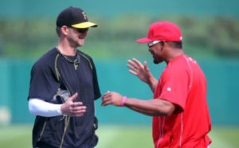 Jun 24, 2015; Pittsburgh, PA, USA; Pittsburgh Pirates pitcher A.J. Burnett (L) and Cincinnati Reds left fielder Marlon Byrd (R) greet each other prior to their game at PNC Park. Mandatory Credit: Charles LeClaire-USA TODAY Sports