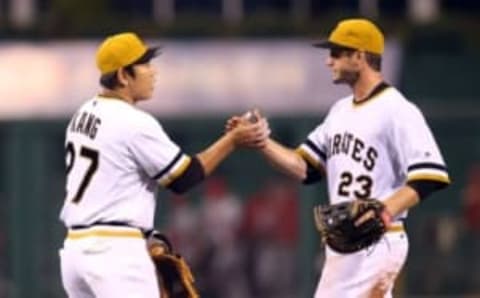 Sep 7, 2016; Pittsburgh, PA, USA; Pittsburgh Pirates third baseman Jung Ho Kang (27) and first baseman David Freese (23) celebrate after defeating the St. Louis Cardinals at PNC Park. The Pirates won 4-3. Mandatory Credit: Charles LeClaire-USA TODAY Sports