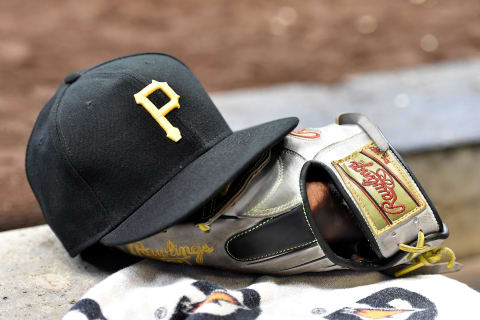 MILWAUKEE, WISCONSIN – SEPTEMBER 21: A detail view of a Pittsburgh Pirates baseball cap and a Rawlings baseball glove during the game against the Milwaukee Brewers at Miller Park on September 21, 2019 in Milwaukee, Wisconsin. (Photo by Quinn Harris/Getty Images)