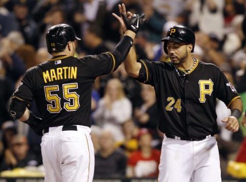 PITTSBURGH, PA – SEPTEMBER 21: Russell Martin #55 of the Pittsburgh Pirates celebrates with teammate Pedro Alvarez #24 at home plate after hitting a two-run home run against the Cincinnati Reds during the second inning of their game on September 21, 2013 at PNC Park in Pittsburgh Pennsylvania. (Photo by David Maxwell/Getty Images)