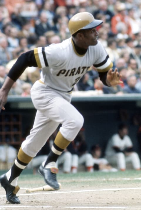 BALTIMORE, MD – CIRCA 1971: Outfielders Roberto Clemente’ #21 of the Pittsburgh Pirates puts the ball in play and runs up the first base line against the Baltimore Orioles during the 1971 World Series circa 1971 at Memorial Stadium in Baltimore, Maryland. Pirates won the series 4-3. (Photo by Focus on Sport/Getty Images)