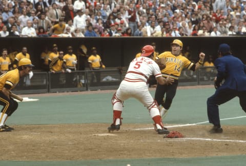 CINCINNATI, OH – CIRCA 1973: Johnny Bench #5 of the Cincinnati Reds blocks the plate in front of Gene Alley #14 of the Pittsburgh Pirates during an Major League Baseball game circa 1973 at Riverfront Stadium in Cincinnati, Ohio. Bench played for the Reds from 1967-83. (Photo by Focus on Sport/Getty Images)