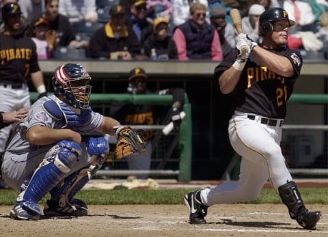 Pittsburgh Pirates’ left fielder Brian Giles (R) hits a 2 RBI single off of Los Angeles Dodgers pitcher Hideo Nomo as Dodgers Catcher Chad Kreuter (L) watches during the third inning on 25 April, 2002 at PNC Park in Pittsburgh, PA. The Pirates defeated the Dodgers 3-2. AFP Photo/David Maxwell (Photo by David MAXWELL / AFP) (Photo credit should read DAVID MAXWELL/AFP via Getty Images)