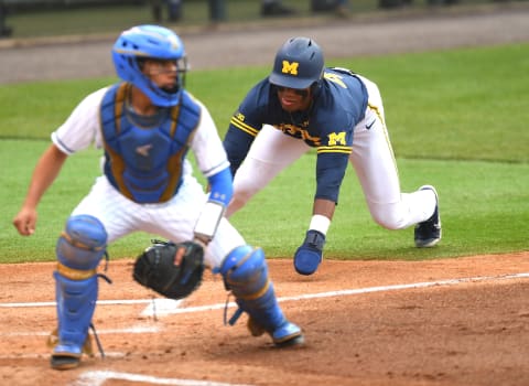 LOS ANGELES, CA – JUNE 07: Ako Thomas #4 of the Michigan Wolverines beats the throw to Noah Cardenas #25 of the UCLA Bruins to score a run on a single by Jesse Franklin #7 of the Michigan Wolverines in the second inning of game 1 of the NCAA Super Regional against the UCLA Bruins at Jackie Robinson Stadium on June 7, 2019 in Los Angeles, California. (Photo by Jayne Kamin-Oncea/Getty Images)