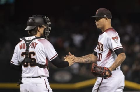 PHOENIX, ARIZONA – MAY 15: Yoan Lopez #50 and John Ryan Murphy #36 of the Arizona Diamondbacks celebrate after closing out the MLB game against the Pittsburgh Pirates at Chase Field on May 15, 2019 in Phoenix, Arizona. (Photo by Jennifer Stewart/Getty Images)