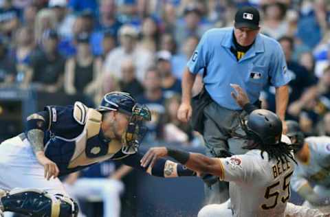 MILWAUKEE, WISCONSIN – JUNE 29: Yasmani Grandal #10 of the Milwaukee Brewers tags out Josh Bell #55 of the Pittsburgh Pirates at home plate in the first inning at Miller Park on June 29, 2019 in Milwaukee, Wisconsin. (Photo by Quinn Harris/Getty Images)