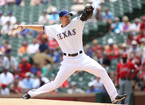 ARLINGTON, TX – JULY 13: Scott Baker #25 of the Texas Rangers throws in the first inning against the Los Angeles Angels of Anaheim at Globe Life Park in Arlington on July 13, 2014 in Arlington, Texas. (Photo by Rick Yeatts/Getty Images)