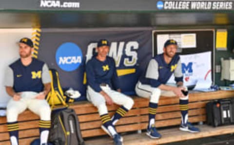 Omaha, NE – JUNE 24: Michigan Wolverines coaches Michael Brdar (L), Nick Schnable (C) and Chris Fetter (R) look on from the dugout prior to game one of the College World Series Championship Series against the Vanderbilt Commodores on June 24, 2019 at TD Ameritrade Park Omaha in Omaha, Nebraska. (Photo by Peter Aiken/Getty Images)