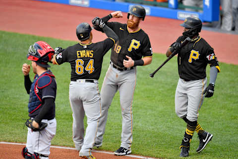 CLEVELAND, OHIO – JULY 20: Phillip Evans #64 celebrates with Colin Moran #19 and Guillermo Heredia #5 of the Pittsburgh Pirates after Evans hit a homer during the second inning against the Cleveland Indians at Progressive Field on July 20, 2020 in Cleveland, Ohio. (Photo by Jason Miller/Getty Images)