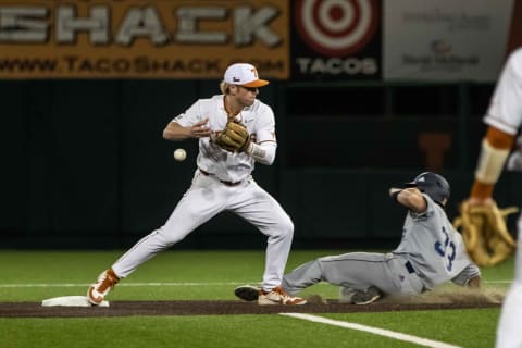 Feb 18, 2020; Texas Longhorns second base Brenden Dixon (1) loses the baseball after maked an out over UTSA’s Nick Thornquist (33) during a game in Austin on Tuesday, Februery 18, 2020. Mandatory Credit: Lola Gomez/American-Statesman – USA TODAY Network