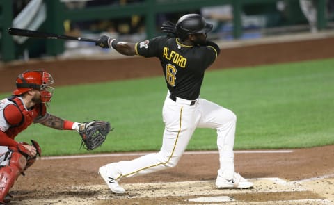 Sep 4, 2020; Pittsburgh, Pennsylvania, USA; Pittsburgh Pirates center fielder Anthony Alford (6) hits a two run triple against the Cincinnati Reds during the fourth inning at PNC Park. Mandatory Credit: Charles LeClaire-USA TODAY Sports