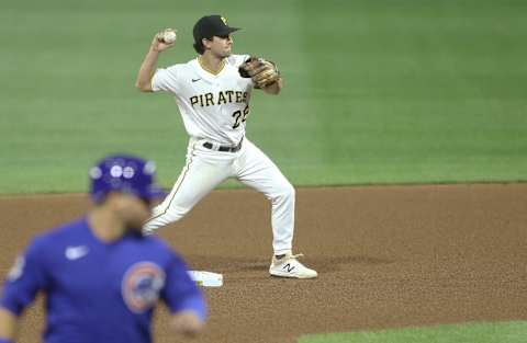 Sep 22, 2020; Pittsburgh, Pennsylvania, USA; Pittsburgh Pirates second baseman Adam Frazier (26) throws to first base to complete a double play against the Chicago Cubs during the fourth inning at PNC Park. Mandatory Credit: Charles LeClaire-USA TODAY Sports