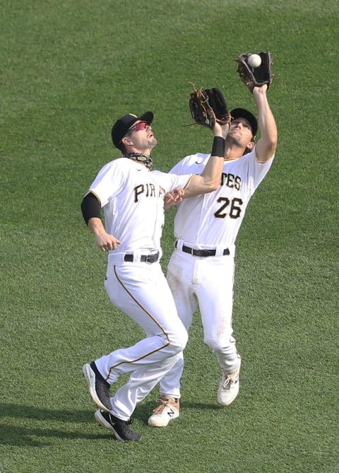 Sep 24, 2020; Pittsburgh, Pennsylvania, USA; Pittsburgh Pirates left fielder Jared Oliva (left) and second baseman Adam Frazier (26) collide securing the final out against the Chicago Cubs during the ninth inning at PNC Park.The Pirates shutout the Cubs 7-0. Mandatory Credit: Charles LeClaire-USA TODAY Sports