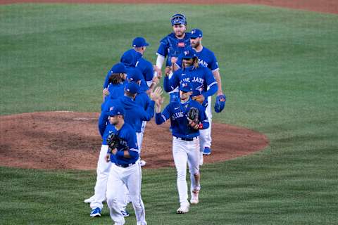 Sep 26, 2020; Buffalo, New York, USA; Toronto Blue Jays third baseman Cavan Biggio (8) and designated hitter Vladimir Guerrero Jr. (27) and pitcher Anthony Bass (52) and designated hitter Alejandro Kirk (85) celebrate with teammates after defeating the Baltimore Orioles at Sahlen Field. Mandatory Credit: Gregory Fisher-USA TODAY Sports