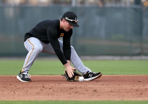 Feb 24, 2021; Bradenton, Florida, USA; Pittsburgh Pirates infielder Adam Frazier (26) takes infield practice during spring training at Pirate City. Mandatory Credit: Jonathan Dyer-USA TODAY Sports