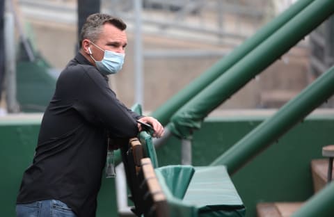 Apr 28, 2021; Pittsburgh, Pennsylvania, USA; Pittsburgh Pirates general manager Ben Cherington observes batting practice from the dugout before the game against the Kansas City Royals at PNC Park. Mandatory Credit: Charles LeClaire-USA TODAY Sports