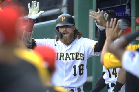 Jul 3, 2021; Pittsburgh, Pennsylvania, USA; Pittsburgh Pirates left fielder Ben Gamel (18) celebrates his solo home run in the dugout against the Milwaukee Brewers during the eighth inning at PNC Park. The Brewers won 11-2. Mandatory Credit: Charles LeClaire-USA TODAY Sports