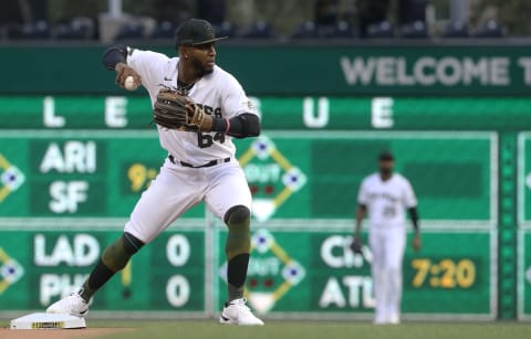 Aug 11, 2021; Pittsburgh, Pennsylvania, USA; Pittsburgh Pirates second baseman Rodolfo Castro (64) throws to first base to complete a double play to end the first inning against the St. Louis Cardinals at PNC Park. Mandatory Credit: Charles LeClaire-USA TODAY Sports