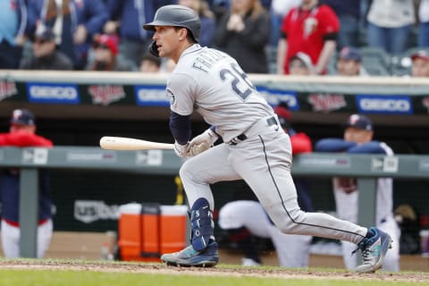 Apr 9, 2022; Minneapolis, Minnesota, USA; Seattle Mariners second baseman Adam Frazier (26) hits an RBI double against the Minnesota Twins in the ninth inning at Target Field. Mandatory Credit: Bruce Kluckhohn-USA TODAY Sports