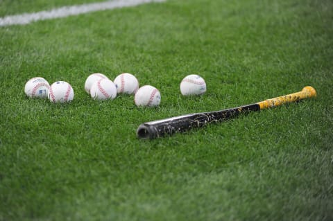 Apr 19, 2022; Milwaukee, Wisconsin, USA; Baseballs and a bat lay on the field at American Family Field. Mandatory Credit: Michael McLoone-USA TODAY Sports