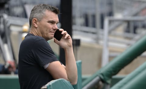 May 24, 2022; Pittsburgh, Pennsylvania, USA; Pittsburgh Pirates general manager Ben Cherington talks on the phone in the dugout before the game against the Colorado Rockies at PNC Park. Mandatory Credit: Charles LeClaire-USA TODAY Sports