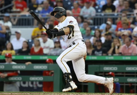 Jul 29, 2022; Pittsburgh, Pennsylvania, USA; Pittsburgh Pirates second baeman Kevin Newman (27) hits a double against the Philadelphia Phillies during the third inning at PNC Park. Mandatory Credit: Charles LeClaire-USA TODAY Sports