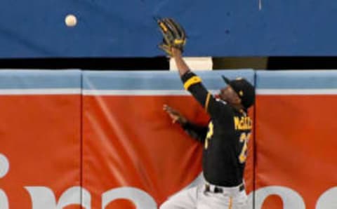 May 8, 2017; Los Angeles, CA, USA; Pittsburgh Pirates center fielder Andrew McCutchen (22) climbs the center field wall but can’t get to the grand slam home run ball hit by Los Angeles Dodgers second baseman Chris Taylor (3) in the first inning of the game at Dodger Stadium. Mandatory Credit: Jayne Kamin-Oncea-USA TODAY Sports