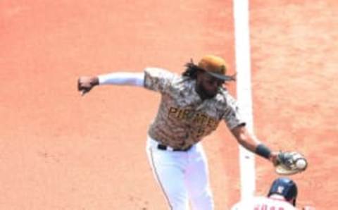 May 18, 2017; Pittsburgh, PA, USA; Washington Nationals starting pitcher Tanner Roark (57) reaches first base on a throwing error as Pittsburgh Pirates first baseman Josh Bell (55) fields the throw during the fourth inning at PNC Park. Mandatory Credit: Charles LeClaire-USA TODAY Sports