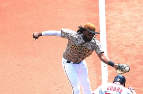 May 18, 2017; Pittsburgh, PA, USA; Washington Nationals starting pitcher Tanner Roark (57) reaches first base on a throwing error as Pittsburgh Pirates first baseman Josh Bell (55) fields the throw during the fourth inning at PNC Park. Mandatory Credit: Charles LeClaire-USA TODAY Sports