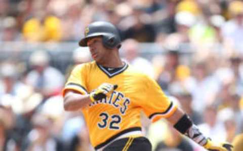 Jul 24, 2016; Pittsburgh, PA, USA; Pittsburgh Pirates catcher Elias Diaz (32) drives in a run against the Philadelphia Phillies during the second inning at PNC Park. Mandatory Credit: Charles LeClaire-USA TODAY Sports